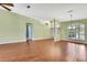 Spacious living area featuring laminate floors, archways, and natural light from front window at 18951 Grand Club Dr, Hudson, FL 34667