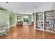 Spacious living room featuring hardwood floors, custom built-in shelving, and an open layout at 18951 Grand Club Dr, Hudson, FL 34667