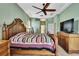 Large bedroom with a ceiling fan and television, great for relaxing and unwinding at 18951 Grand Club Dr, Hudson, FL 34667