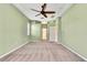 Spacious main bedroom with a neutral color scheme, offering access to an ensuite bathroom and walk-in closet at 18951 Grand Club Dr, Hudson, FL 34667