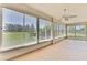 Enclosed patio with tile flooring and many windows revealing an unobstructed backyard view at 18951 Grand Club Dr, Hudson, FL 34667