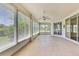 Enclosed patio with tile floors, ceiling fan, and an abundance of natural light at 18951 Grand Club Dr, Hudson, FL 34667