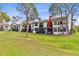 Backyard view showcasing lush greenery, screened-in patios, and tranquil outdoor living spaces at 2073 Skimmer W Ct # 211, Clearwater, FL 33762