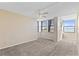 Bright bedroom with ample natural light, neutral carpet, and a ceiling fan for comfortable living at 2073 Skimmer W Ct # 211, Clearwater, FL 33762