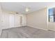 Spacious bedroom with large closet, neutral walls, ceiling fan, and an ensuite bathroom entrance at 2073 Skimmer W Ct # 211, Clearwater, FL 33762