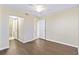 Bedroom featuring hardwood floors, ceiling fan, and an ensuite bathroom entrance at 2073 Skimmer W Ct # 211, Clearwater, FL 33762