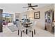 Cozy dining area with golf course view and white chairs in a naturally lit space at 2073 Skimmer W Ct # 211, Clearwater, FL 33762