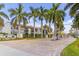 Community entrance with lush landscaping, a gate, and neatly maintained buildings at 2073 Skimmer W Ct # 211, Clearwater, FL 33762