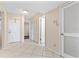 Bright hallway features neutral paint, tile flooring, closet doors, and entry to other rooms at 2073 Skimmer W Ct # 211, Clearwater, FL 33762