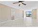 Large living room with tile floors, a ceiling fan, and access to a screened lanai at 2073 Skimmer W Ct # 211, Clearwater, FL 33762