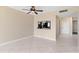 Open living space with tile flooring, a ceiling fan, and a pass-through to the kitchen at 2073 Skimmer W Ct # 211, Clearwater, FL 33762