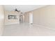 Spacious living room with tile floors, ceiling fan, and open access to the kitchen at 2073 Skimmer W Ct # 211, Clearwater, FL 33762