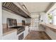 Outdoor kitchen area with multiple grills and a counter with sink at 2073 Skimmer W Ct # 211, Clearwater, FL 33762