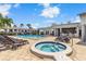 Community pool and jacuzzi with seating and a bar area at 2073 Skimmer W Ct # 211, Clearwater, FL 33762