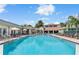 Beautiful community pool with dining space, umbrellas, and plenty of lounging space to enjoy the weather at 2073 Skimmer W Ct # 211, Clearwater, FL 33762