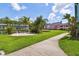 Beautiful backyard featuring lush green grass, tropical landscaping, and walking path at 20890 Negril Ct # 5, Lutz, FL 33558