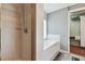 Well-lit bathroom with a tiled shower enclosure and a soaking tub, enhanced by a conveniently located storage closet at 20890 Negril Ct # 5, Lutz, FL 33558
