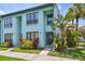 Charming light blue two-story townhome featuring tropical landscaping and dark trim at 20890 Negril Ct # 5, Lutz, FL 33558