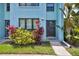 Charming light blue two-story townhome featuring tropical landscaping and dark trim at 20890 Negril Ct # 5, Lutz, FL 33558