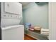 Stacked washer and dryer with storage shelving and clean towels in the laundry area at 20890 Negril Ct # 5, Lutz, FL 33558