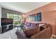 Living room featuring a comfortable sofa, large window and unique artwork at 20890 Negril Ct # 5, Lutz, FL 33558