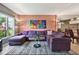 Stylish living room showcasing a plum sectional sofa and decorative artwork at 20890 Negril Ct # 5, Lutz, FL 33558