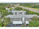 Aerial view of a multi-story condo building with mature trees and a highway nearby at 21103 Patio View Ct # 3305, Lutz, FL 33558