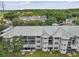 Aerial view of an apartment building featuring a metal roof, multiple stories, and beautiful landscaping at 21103 Patio View Ct # 3305, Lutz, FL 33558