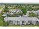 Aerial view of a multi-story apartment building with a metal roof, surrounded by greenery and mature trees at 21103 Patio View Ct # 3305, Lutz, FL 33558