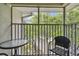 Comfortable screened balcony with outdoor seating and view of lush green trees at 21103 Patio View Ct # 3305, Lutz, FL 33558