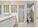 Bright bathroom with a vanity, toilet, and shower, accented by a decorative glass block window at 21103 Patio View Ct # 3305, Lutz, FL 33558