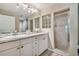 Well-lit bathroom with double sinks, shower, decorative glass block window, and ample counter space at 21103 Patio View Ct # 3305, Lutz, FL 33558