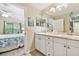 Bright bathroom with double sinks, ample counter space, and easy access to the main bedroom at 21103 Patio View Ct # 3305, Lutz, FL 33558