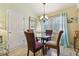 Cozy dining area with modern chandelier and seating for four at 21103 Patio View Ct # 3305, Lutz, FL 33558