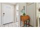 Inviting entryway with white door, decorative secretary, and coastal decor at 21103 Patio View Ct # 3305, Lutz, FL 33558