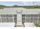 Exterior view of a three-story condo building with a metal roof and exterior walkways with metal railings at 21103 Patio View Ct # 3305, Lutz, FL 33558