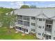 An elevated exterior angle of an apartment building highlighting screened porches and well-manicured grounds at 21103 Patio View Ct # 3305, Lutz, FL 33558
