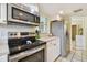 Kitchen featuring stainless steel appliances and stylish over-the-range microwave at 21103 Patio View Ct # 3305, Lutz, FL 33558