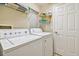 Functional laundry room with washer, dryer, and shelving for storage, making chores a breeze at 21103 Patio View Ct # 3305, Lutz, FL 33558