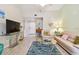 Well-lit living room with tile flooring, comfortable seating, and modern entertainment center at 21103 Patio View Ct # 3305, Lutz, FL 33558