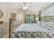 Bright bedroom with a large bed, ceiling fan, and dresser with mirror, offers space and comfort at 21103 Patio View Ct # 3305, Lutz, FL 33558