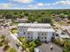 A modern townhouse complex is captured from above on a sunny day with a cityscape in the distance at 2205 16Th N St, St Petersburg, FL 33704