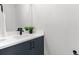 Modern bathroom features sleek vanity with white countertop, dark blue cabinets, and updated faucet at 2205 16Th N St, St Petersburg, FL 33704