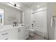 Elegant bathroom with a large mirror, white vanity, black hardware, and a shower-tub combination at 2205 16Th N St, St Petersburg, FL 33704