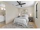 Inviting bedroom with a ceiling fan, artwork above the headboard, and light hardwood floors at 2205 16Th N St, St Petersburg, FL 33704