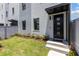 Modern townhome's front entrance features a black door and small landscaped garden at 2205 16Th N St, St Petersburg, FL 33704