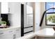 Modern kitchen featuring sleek white refrigerator, cabinets, and a view of the outdoors at 2205 16Th N St, St Petersburg, FL 33704