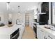 Sleek kitchen featuring white cabinets, modern appliances, a spacious island, and stylish finishes at 2205 16Th N St, St Petersburg, FL 33704