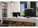 Modern kitchen with black backsplash, white island with seating, and stainless steel vent hood at 2205 16Th N St, St Petersburg, FL 33704