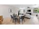 Open-concept living and dining area boasts hardwood floors, stylish furniture, and bright, natural light at 2205 16Th N St, St Petersburg, FL 33704